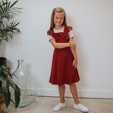 KID'S RUFFLE PINAFORE | CRANBERRY